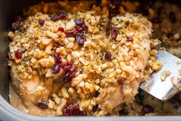 serving a chicken breast with stuffing from a slow cooker.