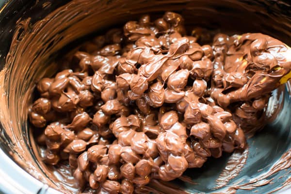 melted chocolate and almonds in a slow cooker