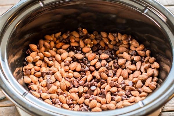 almonds and chocolate chips mixed together in a slow cooker.