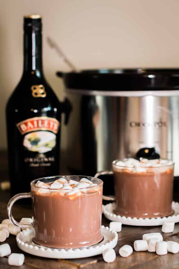 2 cups of baileys hot chocolate with bottle of baileys behind it.