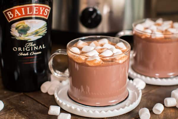 baileys hot chocolate in clear mugs with marshmallows on top.