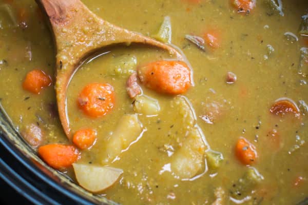 ultra close up shot of split peas stew with large chunks of carrots and potatoes.