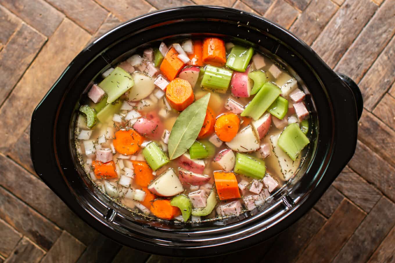 uncooked split pea stew in a slow cooker.