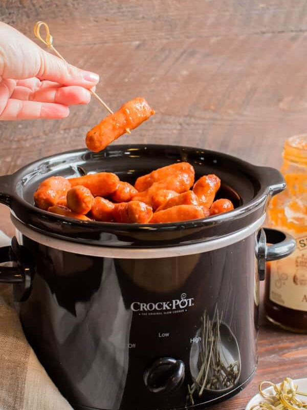 slow cooker with apple butter little smokies in it.