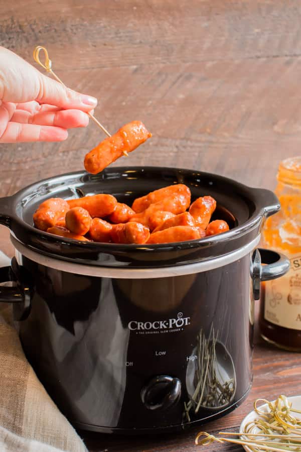 slow cooker with apple butter little smokies in it.