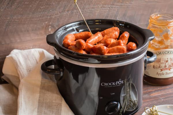 slow cooker full of apple butter little smokies, done cooking.