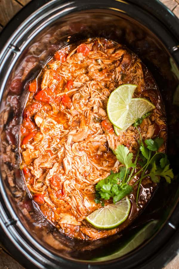 shredded salsa chicken in a slow cooker.