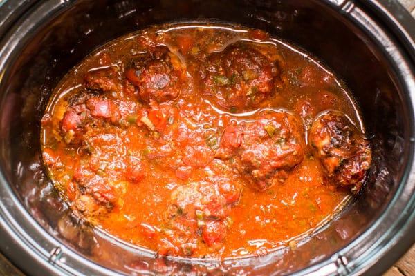 chicken thighs in a slow cooker cooked with homemade salsa.