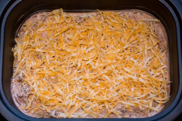 uncooked bean dip with cheese on top.