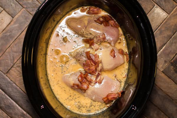 uncooked chicken and gravy mix in a slow cooker