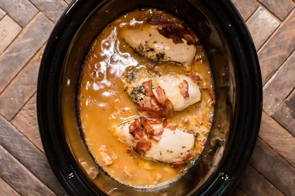 cooked chicken and gravy in a slow cooker.