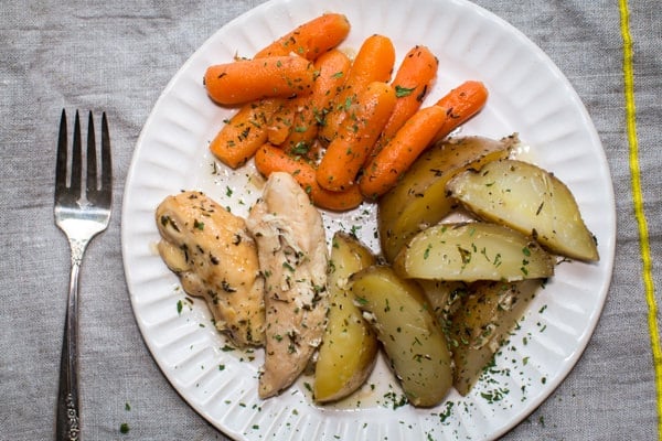 chicken tenders, potatoes and carrots on a white plate.