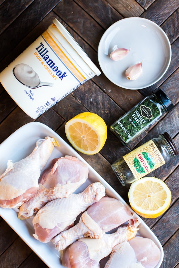 yogurt, drumsticks, garlic and seasonings on a table