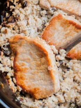 wild rice mix and pork chops in a slow cooker.
