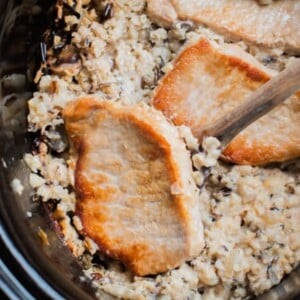 wild rice mix and pork chops in a slow cooker.