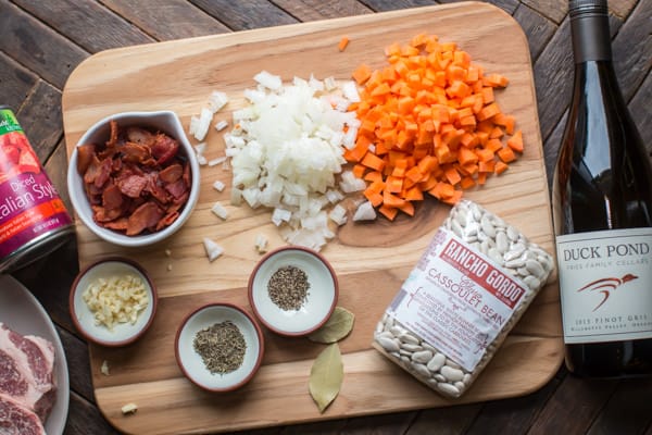 bacon, pork, white beans, carrots, onion, garlic, white beans, and seasonings.