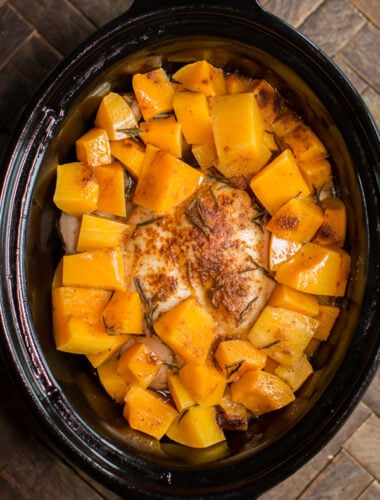 whole chicken done cooking in slow cooker with butternut squash.