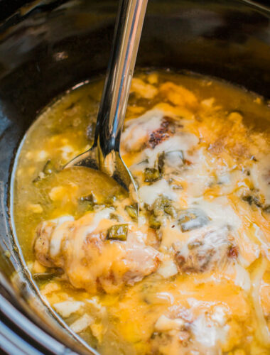 saucy green chile chicken thighs in a slow cooker