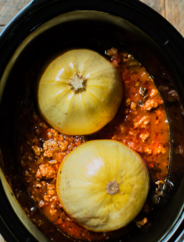 2 spaghetti squash halves on turkey meat sauce.