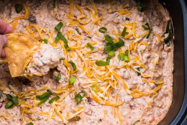 sausage dip with cheese and green onion on top.