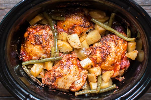 4 chicken thighs with gold potatoes and green beans in the slow cooker.