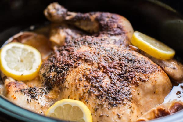 whole chicken in a slow cooker with lemons