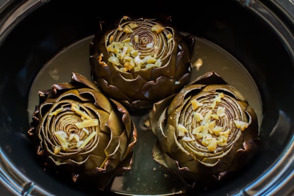 3 artichokes in a slow cooker, done cooking.