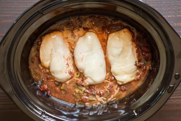 3 chicken breasts in a slow cooker, done cooking.