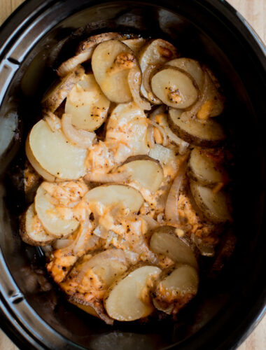 sliced potatoes, onions and russet potates in a slow cooker