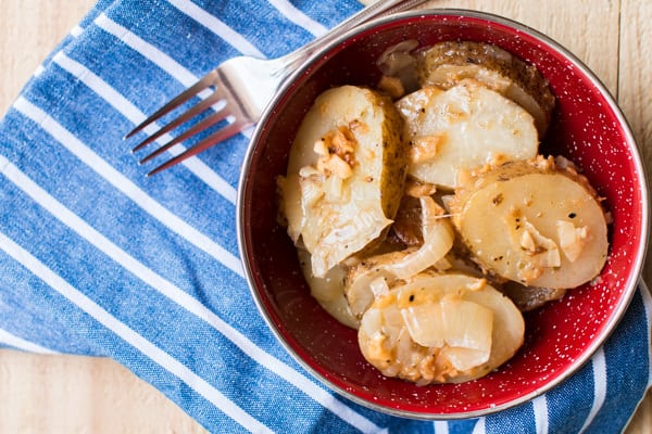 close up of campfire potatoes in a red bowl