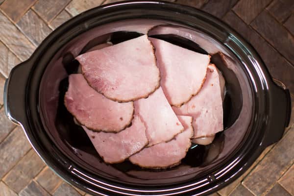 ham on top of chicken in a slow cooker