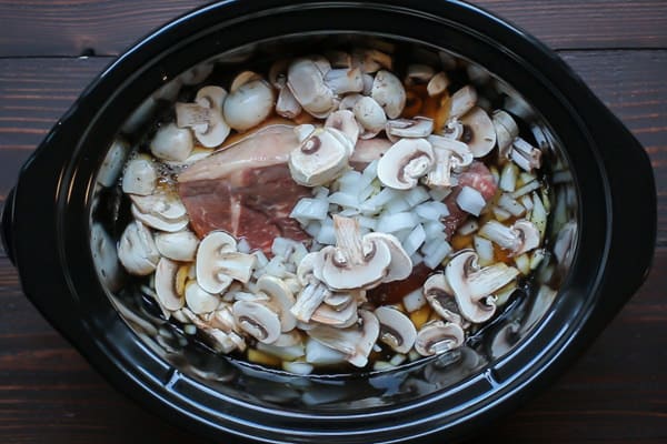 raw beef, onion, mushrooms and broth in a slow cooker