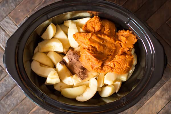 sliced apples, seasonings, and pumpkin puree in a slow cooker