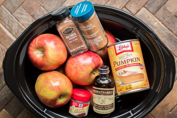 apples, can of pumpkin, nutmeg, cinnamon, vanilla and cloves in a slow cooker.