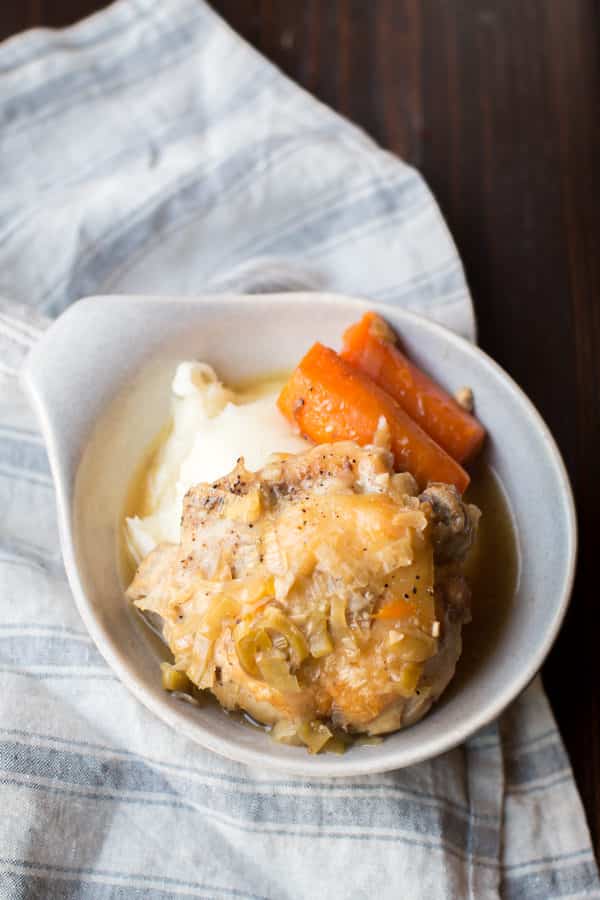 bowl with mashed potatoes, carrots and chicken thigh