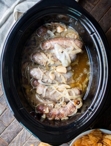 cooked brats in a slow cooker in a buttery sauce.