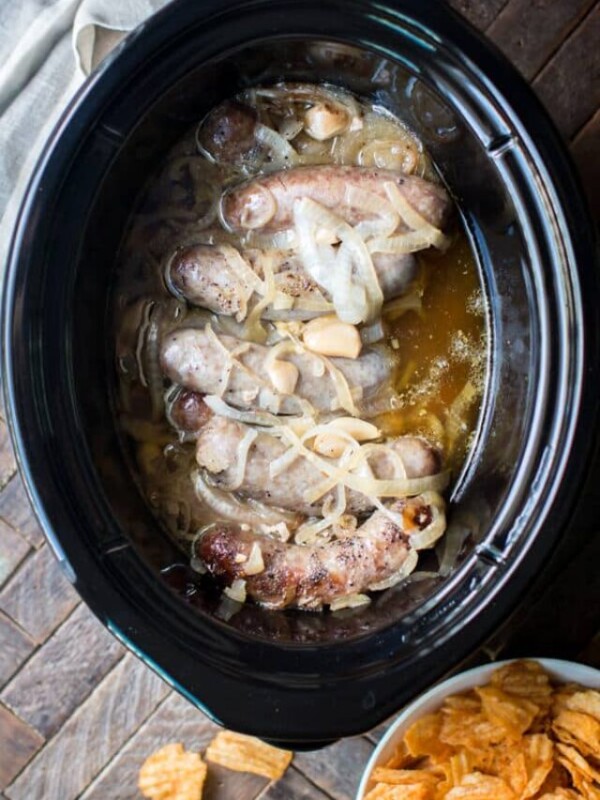 beer and garlic brats done cooking in a slow cooker.