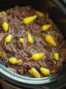 shredded pot roast with spicy peppers on top.