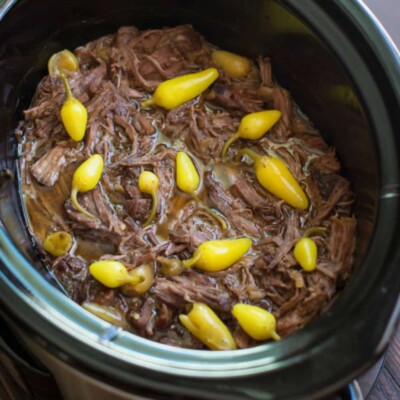 shredded pot roast with spicy peppers on top.