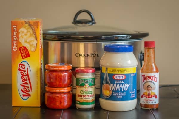 mayo, velveeta, pimentos, horseradish and hot sauce in front of slow cooker.