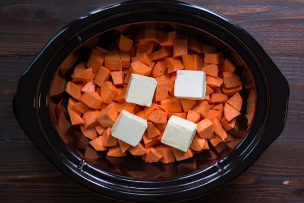 cubed sweet potatoes with butter pats on top.