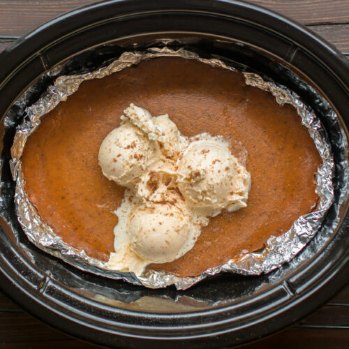 slow cooker lined with foil. Pumpkin pie with ice cream on top in it.