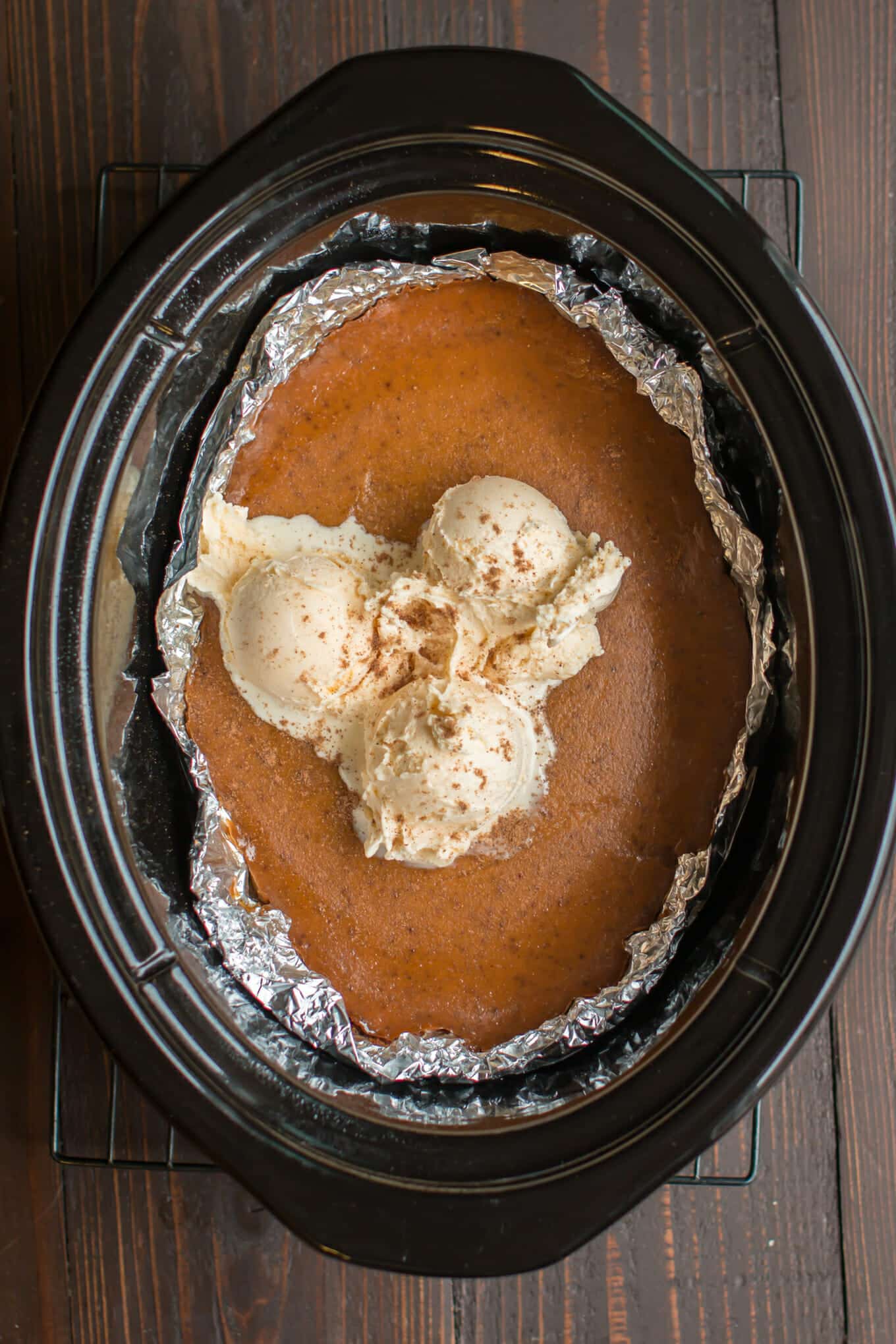 crustless pumpkin pie cooked in the slow cooker with ice cream on top.