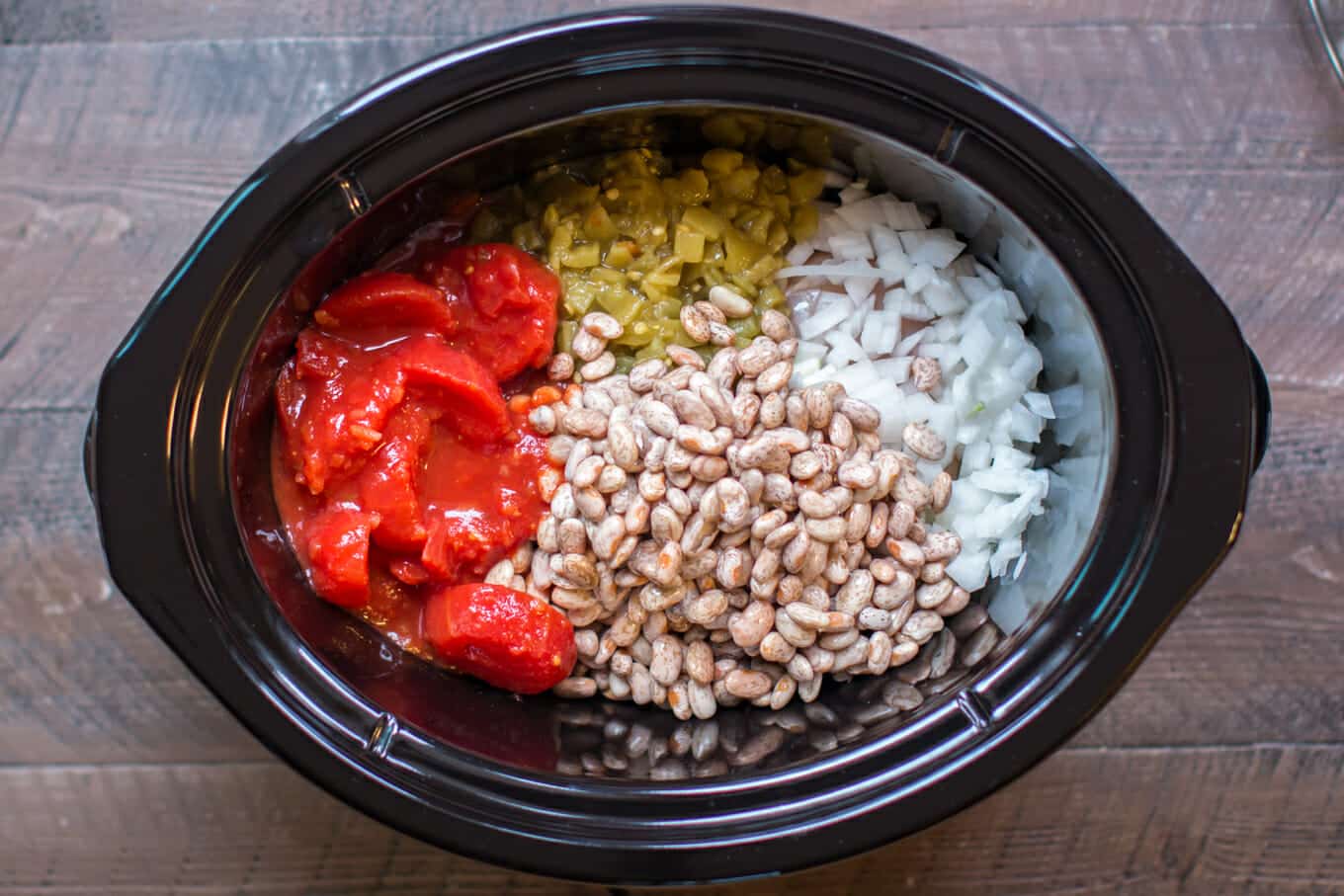 pinto beans, tomatoes, green chiles and onion in a slow cooker