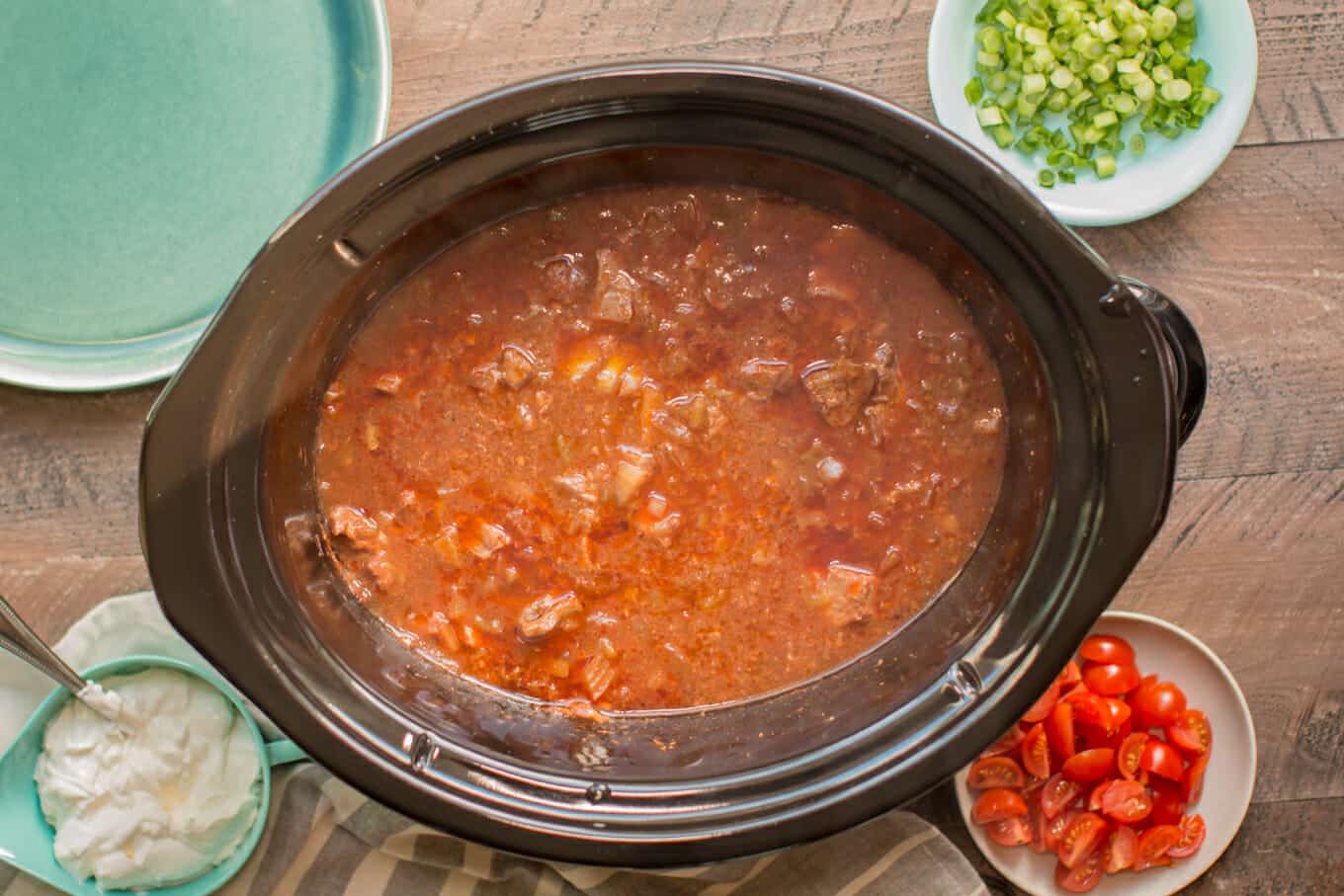 beef cooked in sauce in slow cooker.