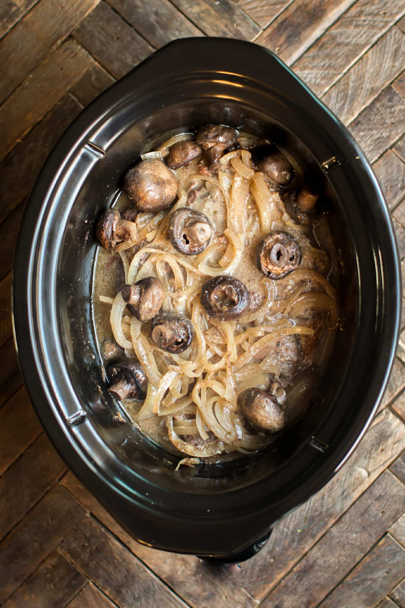 roast with onions, horseradish and mushrooms in a slow cooker