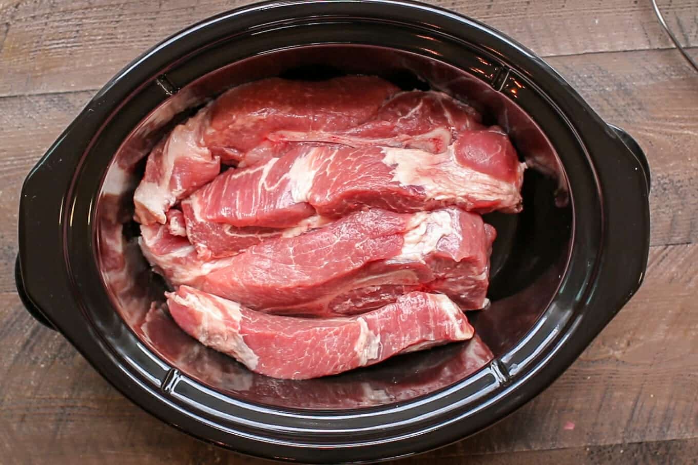 raw country style ribs in a slow cooker.