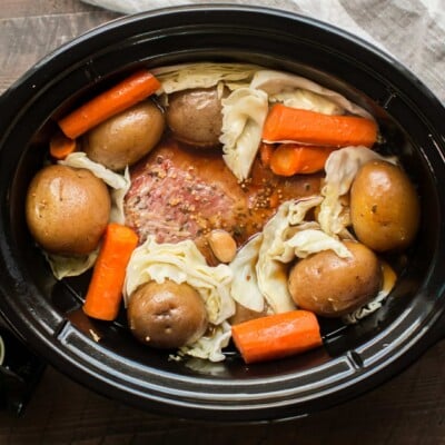 corned beer, cabbage, carrots, and potatoes in slow cooker.