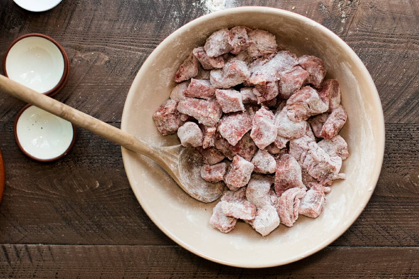 beef cubes covered in flour in a bowl