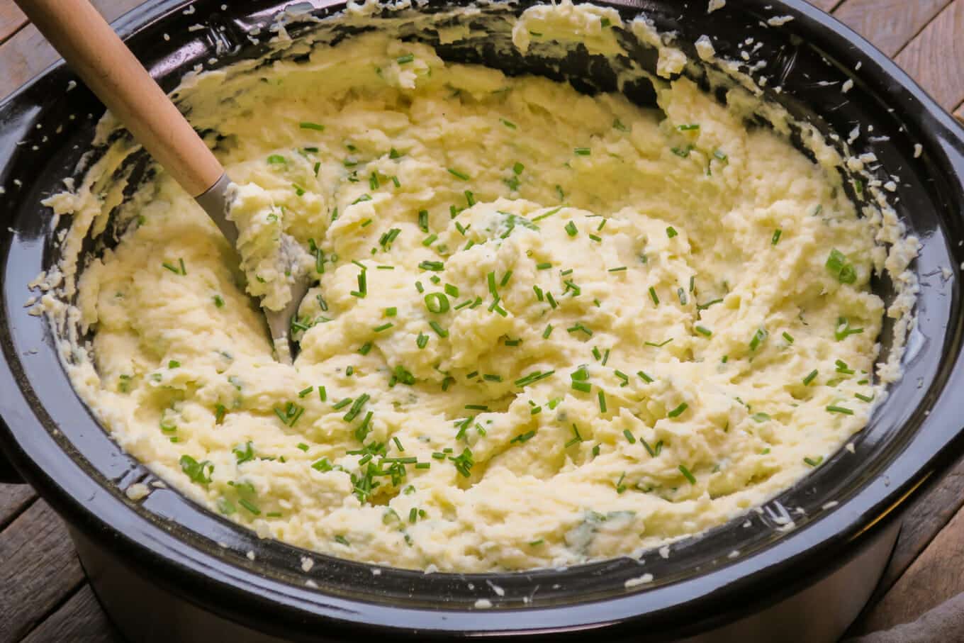 close up of sour cream and onion mashed potatoes in slow cooker